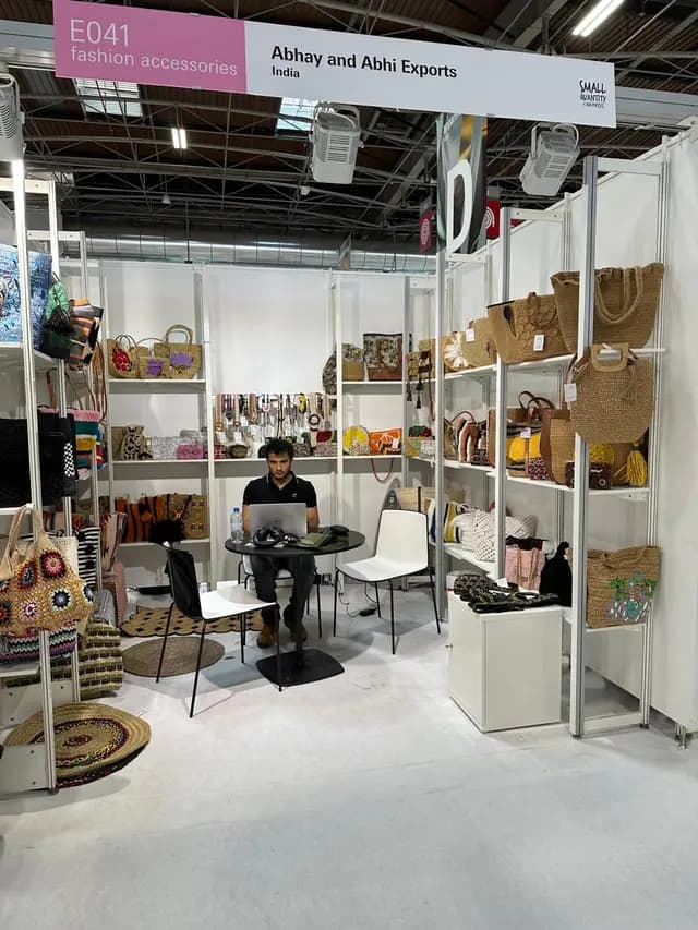 A bustling marketplace with colorful stalls displaying handmade bags, scarves, and accessories
